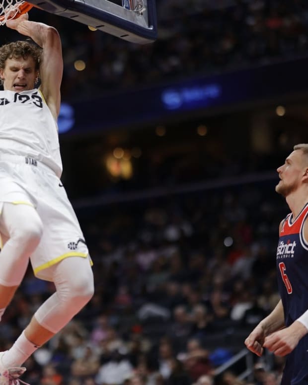Nov 12, 2022; Washington, District of Columbia, USA; Utah Jazz forward Lauri Markkanen (23) dunks the ball as Washington Wizards center Kristaps Porzingis (6) looks on in the fourth quarter at Capital One Arena. Mandatory Credit: Geoff Burke-USA TODAY Sports